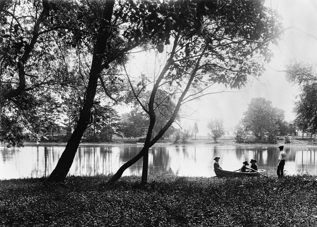 Detail of 1890s 1900 Older Brother Watching Three Younger Children In Rowboat On Small Lake by Corbis