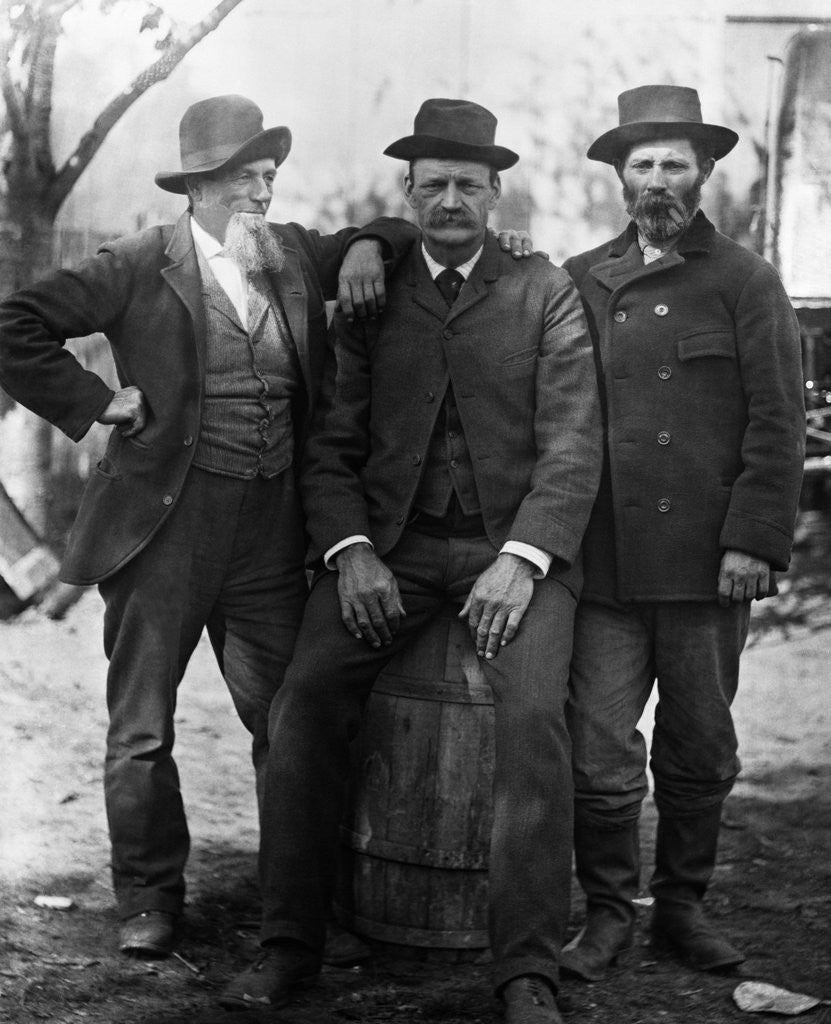 Detail of 1890s 1900 Three Men With Beard Or Mustache Wearing Hats One Sitting On Barrel by Anonymous