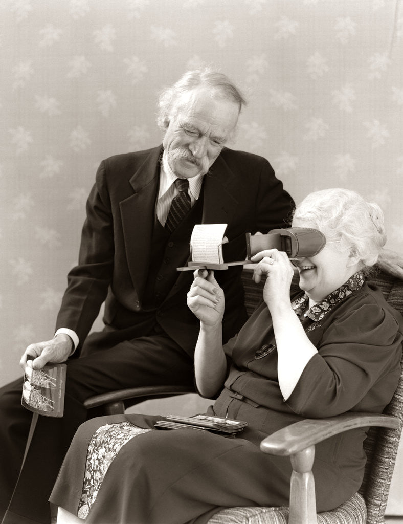 Detail of 1940s Older Senior Couple Man Woman Viewing Photographs By Stereopticon Stereoscope by Corbis
