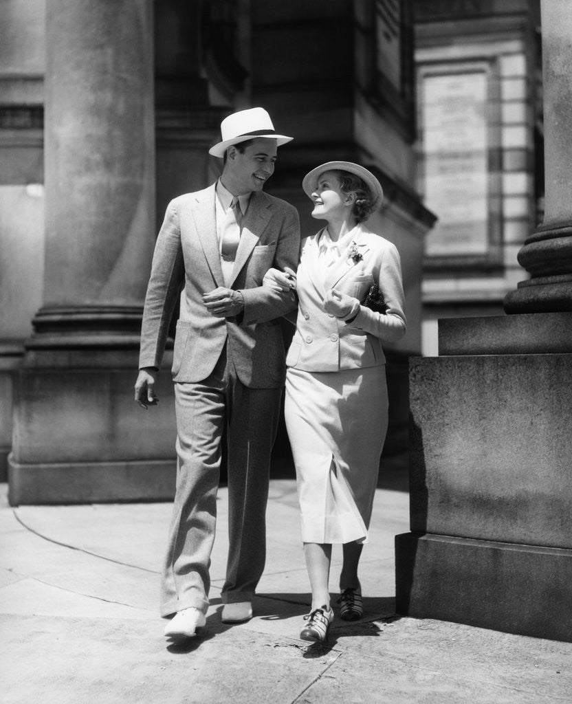 Detail of 1930s Couple In Suits And Hats Walking Arm In Arm by Anonymous