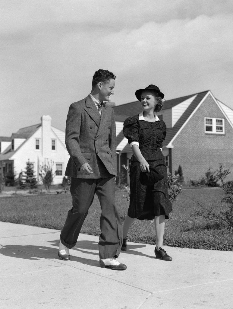 Detail of 1940s Teenage Couple Walking On Suburban Sidewalk by Corbis