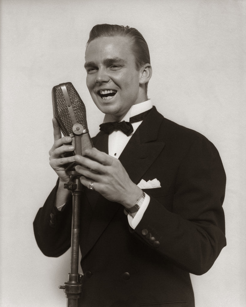 Detail of 1920s 1930s Man Radio Singer Entertainer Crooner In Tuxedo Singing Into Microphone by Anonymous