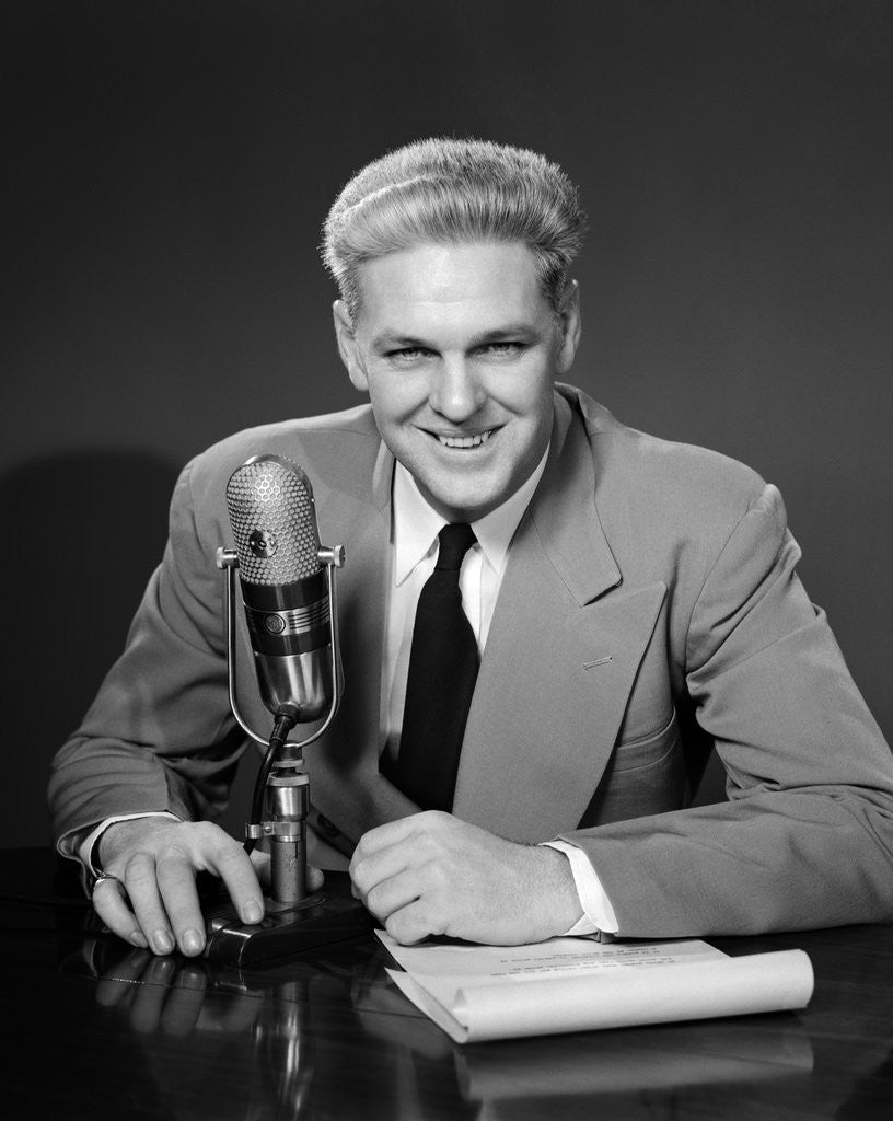 Detail of 1950s Man Radio Announcer Newscaster Sitting Speaking At Microphone Studio Indoor by Corbis