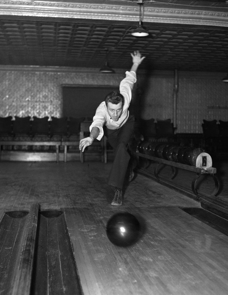Detail of 1930s Man Bowling Just Releasing Ball Into Alley by Corbis