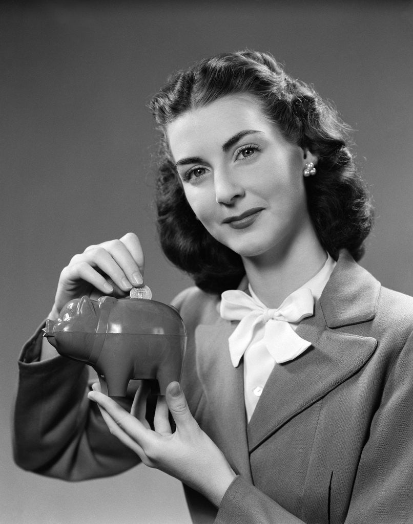 Detail of 1940s Woman Putting Change Into Piggy Bank by Anonymous