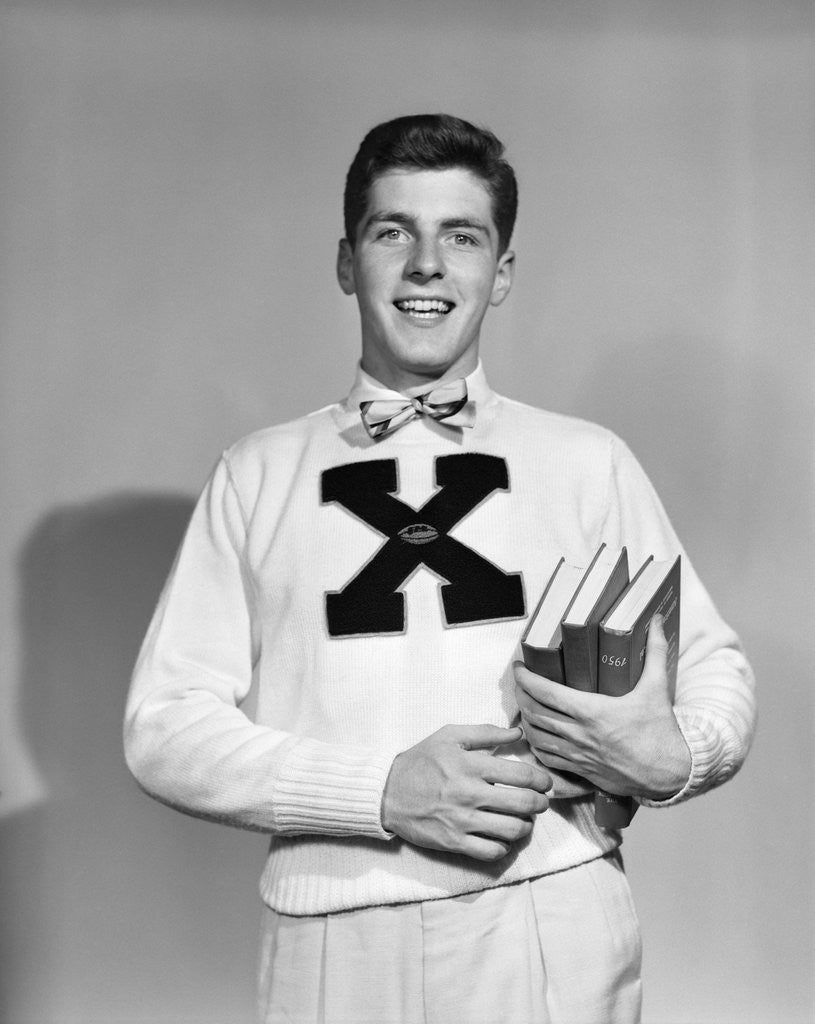 Detail of 1940s 1950s Portrait Boy Student Carrying Books Wearing Football Letter Sweater by Anonymous