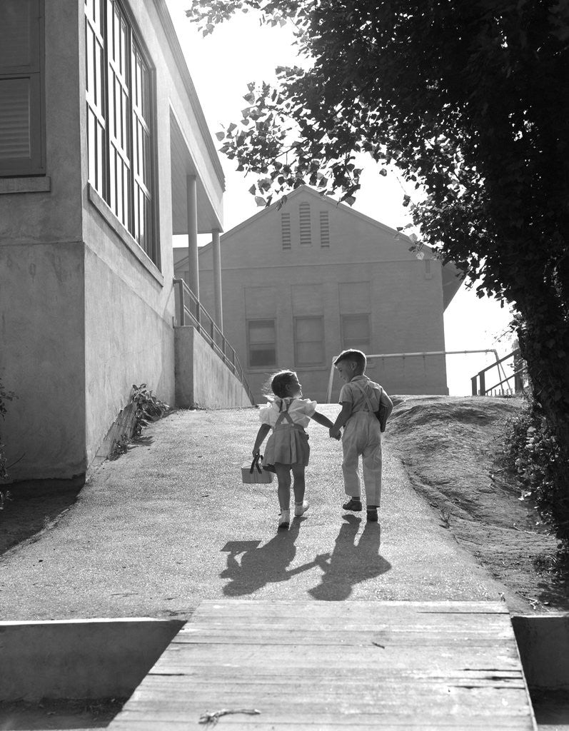 Detail of 1940s 1950s Two School Children Boy And Girl Walking To School Holding Hands by Anonymous