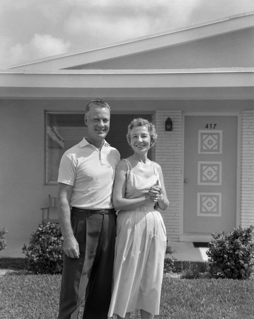 Detail of 1950s Older Man Woman Senior Citizen Standing Together In Retirement Home Front Yard by Anonymous