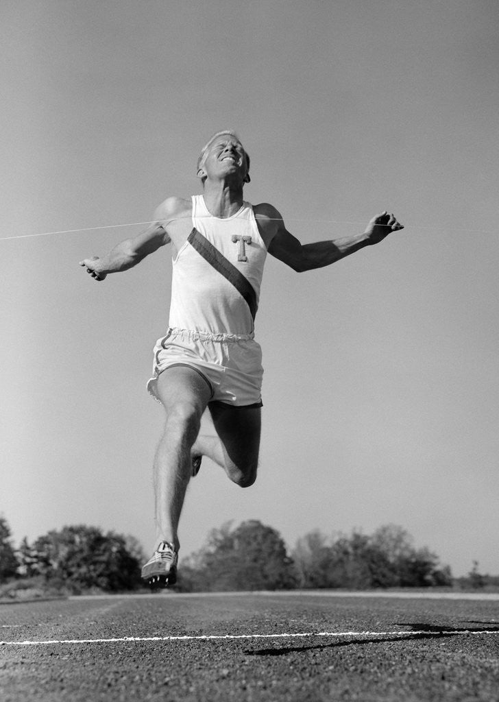 Detail of 1960s Man Running Winning Sprinting Across The Finish Line Outdoor by Anonymous