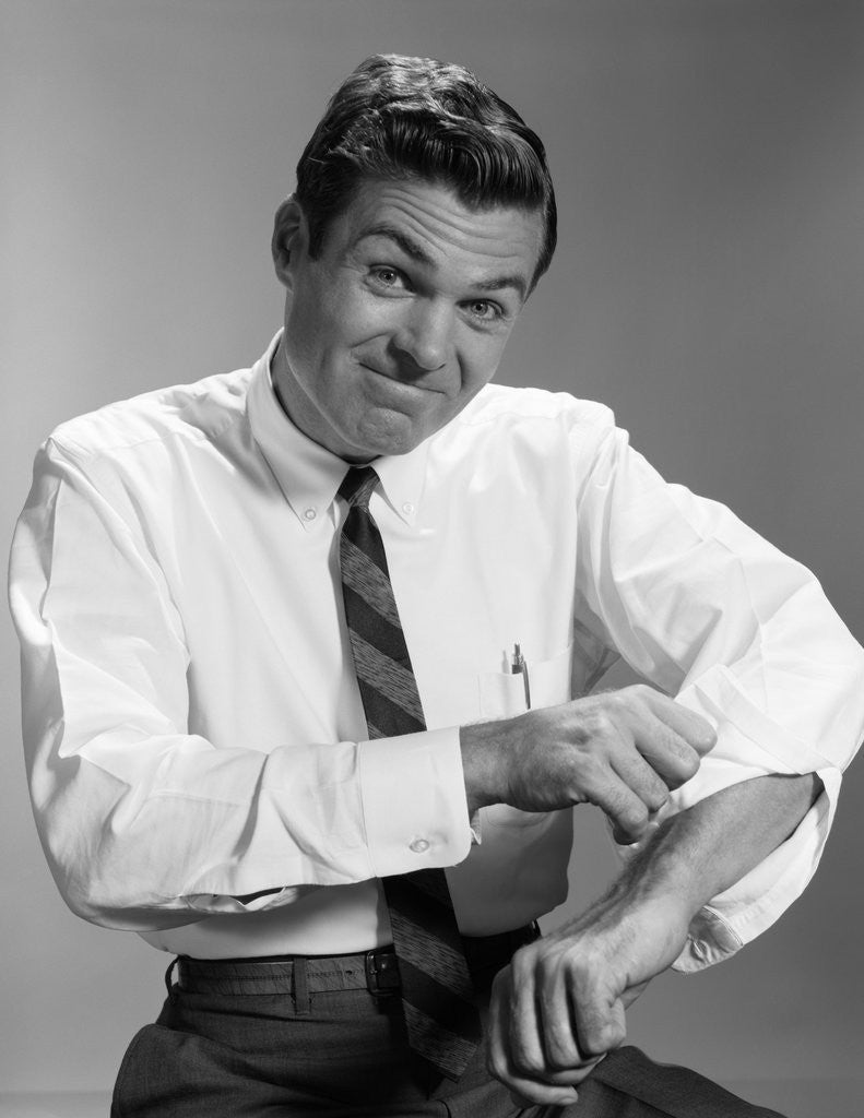 Detail of 1960s Man In Business Shirt And Tie Rolling Up His Sleeves To Work Determined Look Studio by Anonymous