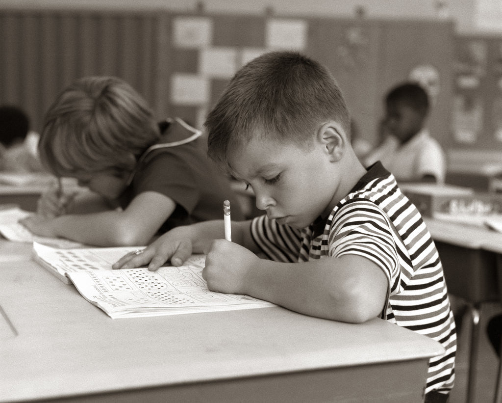 Detail of 1960s Boy Striped T-Shirt Elementary School Classroom Sitting Desk Writing Test by Anonymous