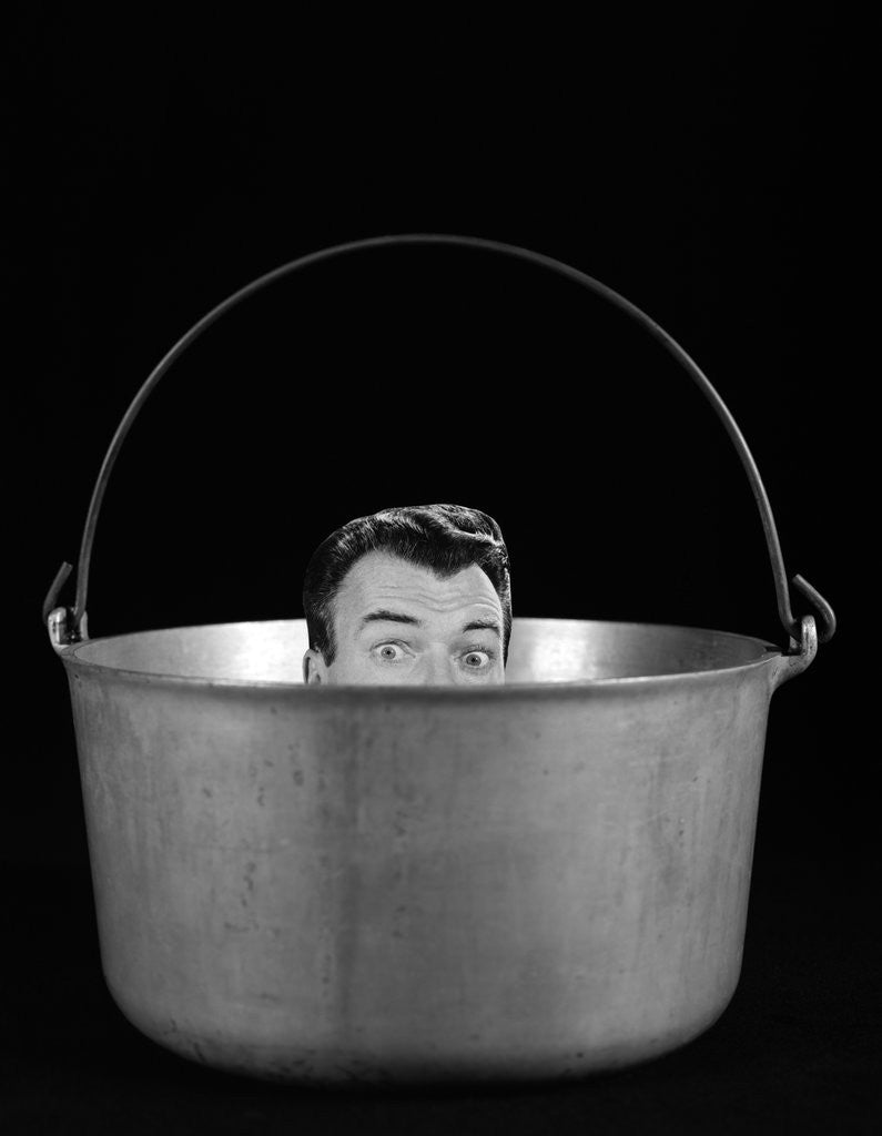 Detail of 1950s 1960s Symbolic Montage Portrait Man In The Soup Looking Wide Eyed From Inside The Kettle by Corbis