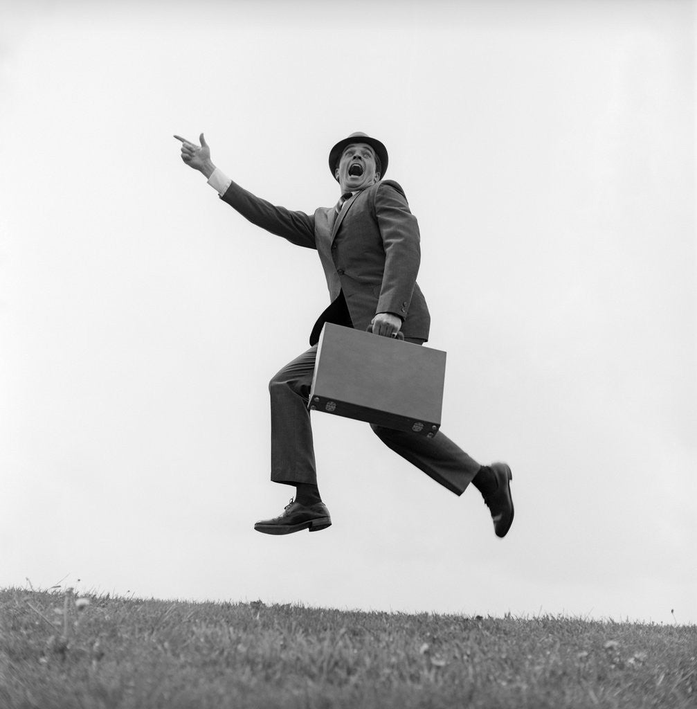 1960s Businessman Carrying A Briefcase Running Yelling And Jumping In The Air posters prints by Corbis