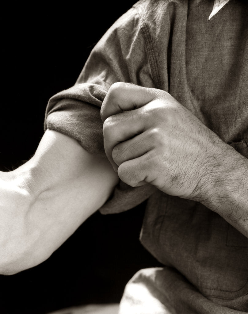 Detail of 1920s 1930s 1940s 1950s Man Rolling Up Sleeve Symbolic Get To Work by Anonymous