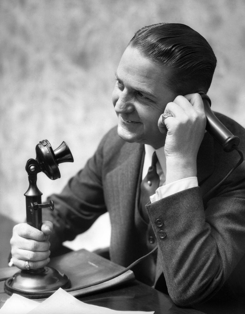 Detail of 1920s Businessman Talking Into Candlestick Telephone by Corbis