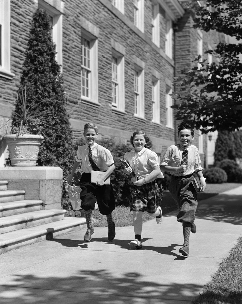 Detail of 1940s Three School Children 2 Boys 1 Girl Running Down Sidewalk Carrying Books by Corbis