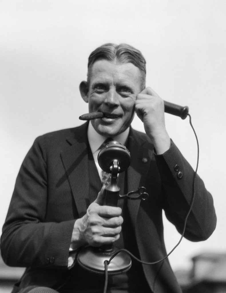Detail of 1920s Portrait Of Businessman Talking On Candlestick Phone Smoking Cigar Office Indoor by Anonymous