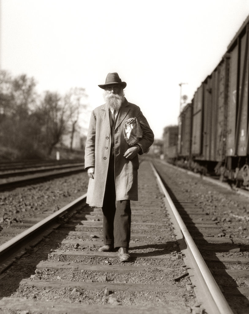 Detail of 1930s Great Depression Era Man Homeless Hobo Walking Down Railroad Tracks by Corbis