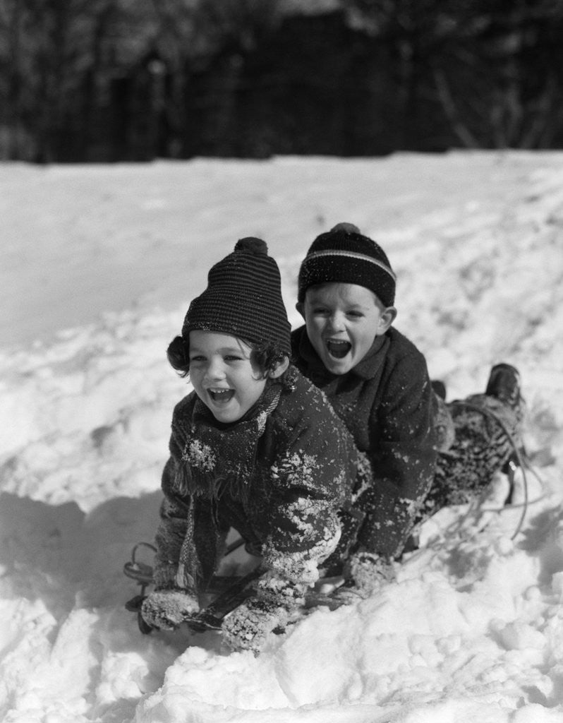 Detail of 1930 1930s Boy And Girl Laughing Sledding In Snow by Corbis