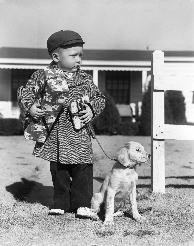 Detail of 1940s Boy With Puppy On Leash Holding Christmas Present by Anonymous