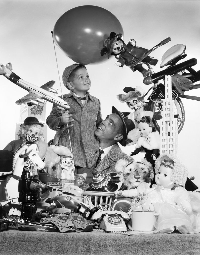 Detail of 1950s Father With Son Holding Balloon Surrounded By Toys and Stuffed Animals by Corbis