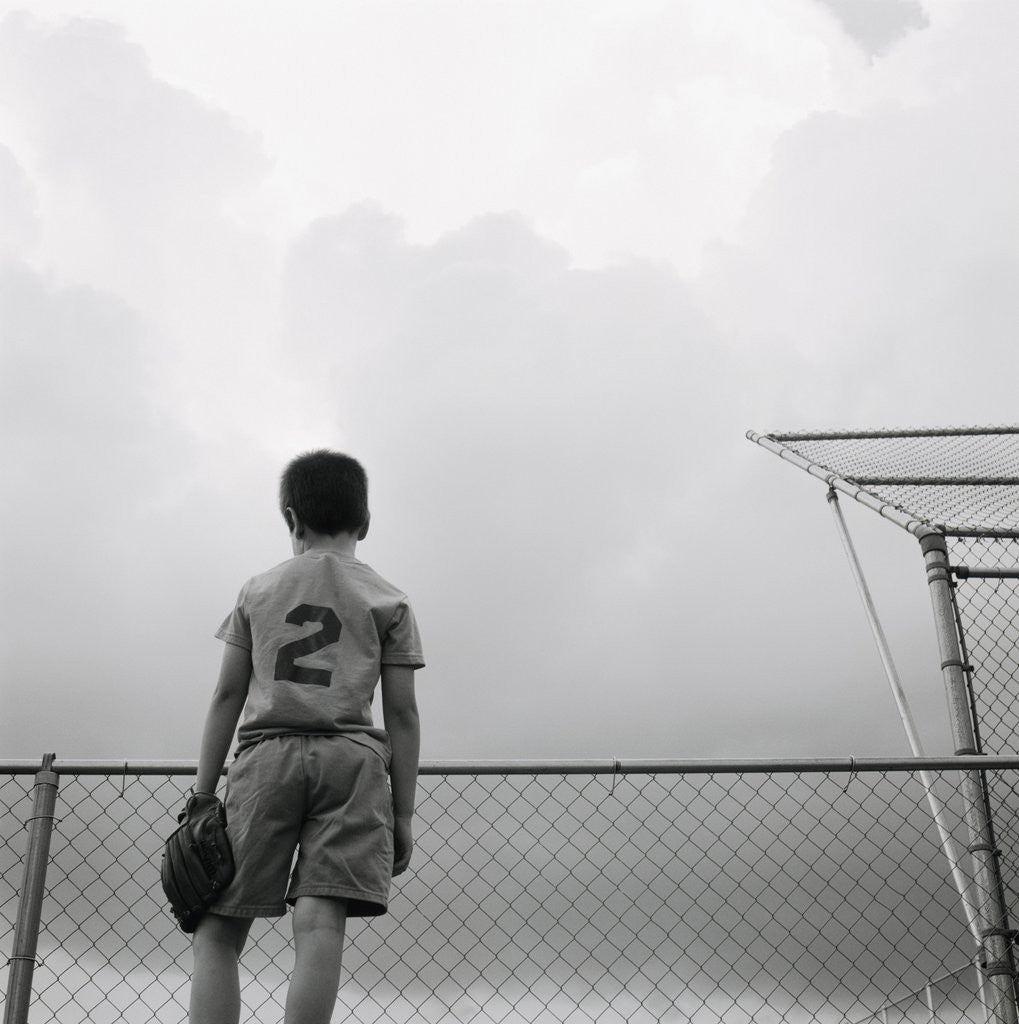 Detail of Boy in baseball uniform by Corbis