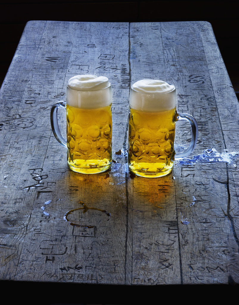 Detail of Two Glass Mugs of Beer on Table by Anonymous