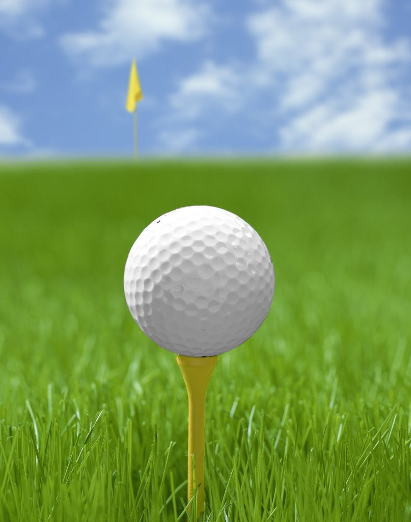 Golf ball on tee by Corbis