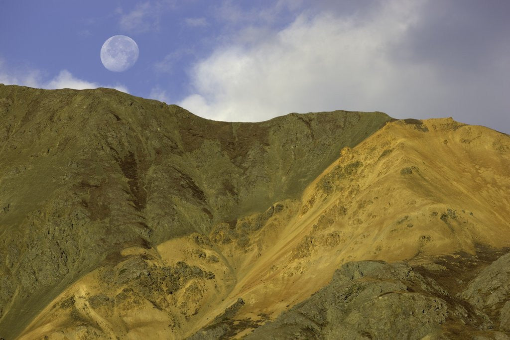 Detail of Full moon setting over mountain in Kluane National Park by Corbis