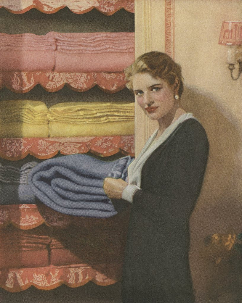 Detail of Woman puting away blanket in linen closet by Anonymous