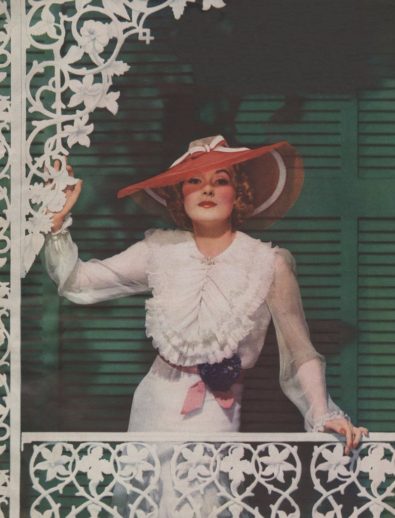 Detail of Woman with picture hat on front porch by Anonymous