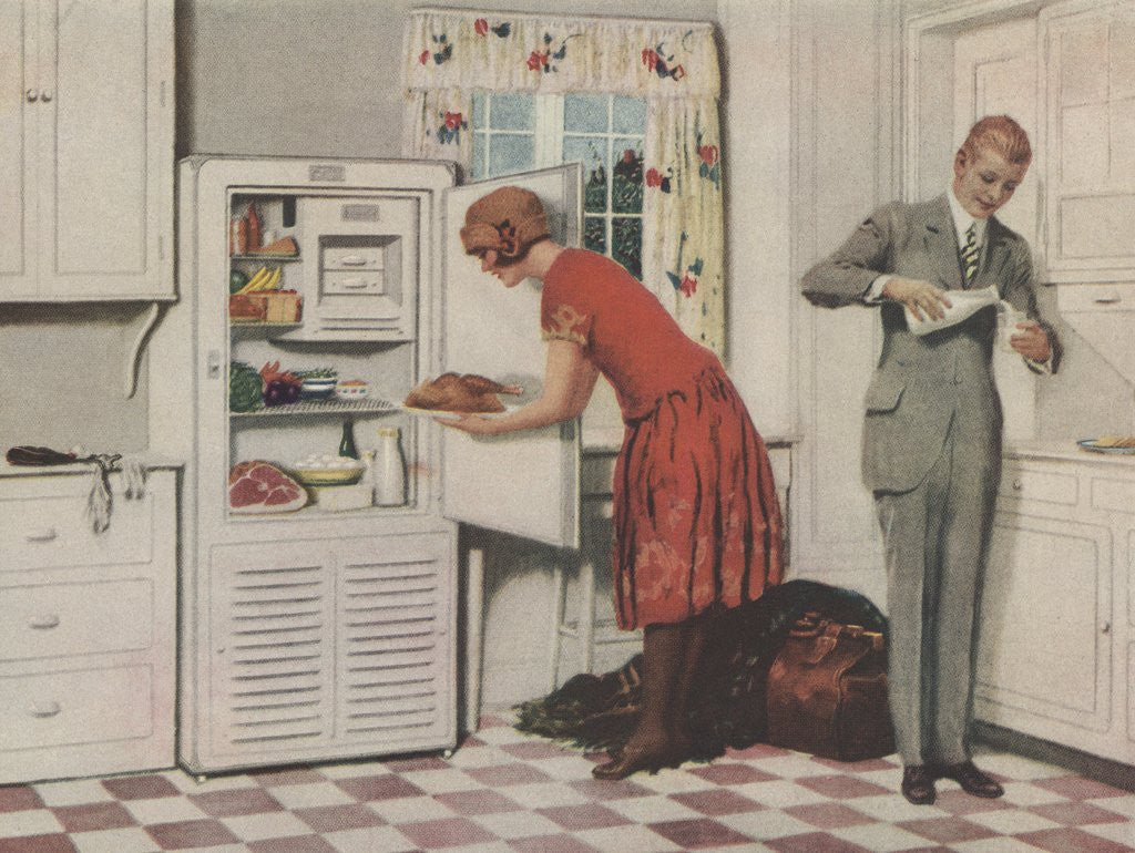 Detail of Man and woman in kitchen getting food by Corbis