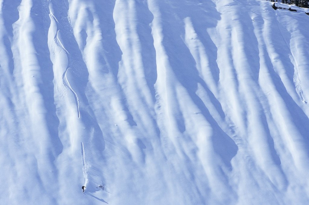 Detail of Man Snowboarding in the Backcountry of Roger's Pass, British Columbia, Canada. by Corbis