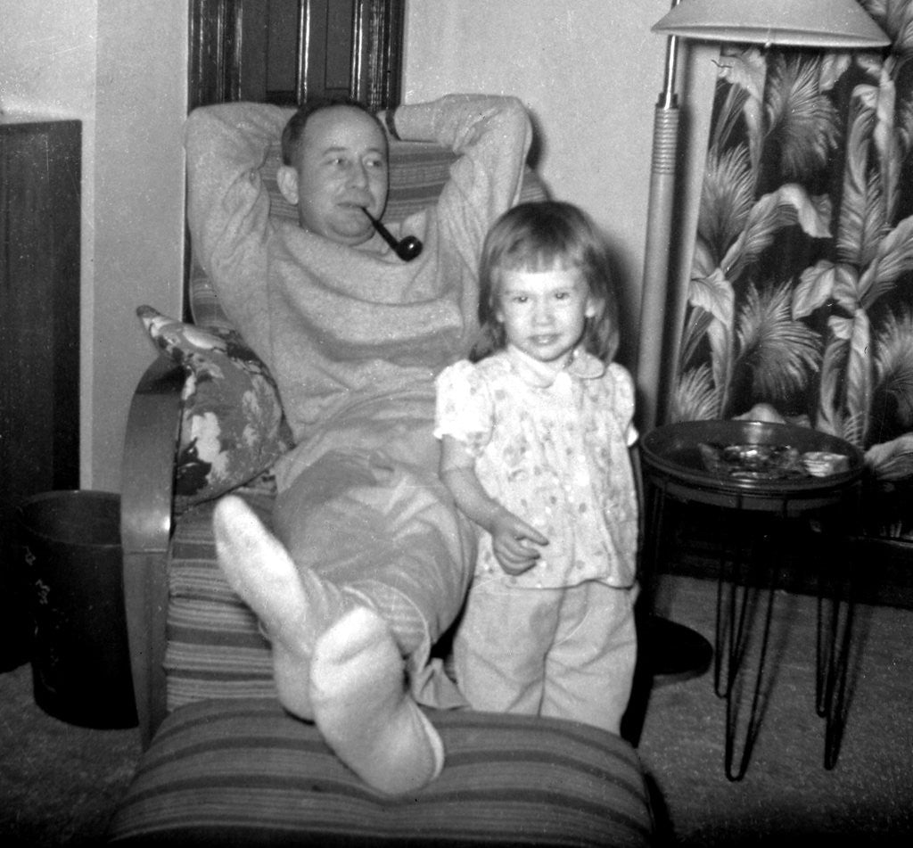 Detail of Dad relaxes and smokes his pipe with his four year old daughter, ca. 1958 by Anonymous