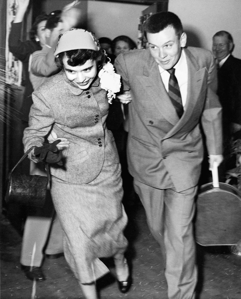 Detail of A couple leave their wedding and onto their honeymoon, ca. 1955 by Anonymous