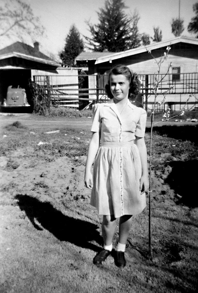 Detail of A teenage girl poses in front of her California house, ca. 1942 by Corbis