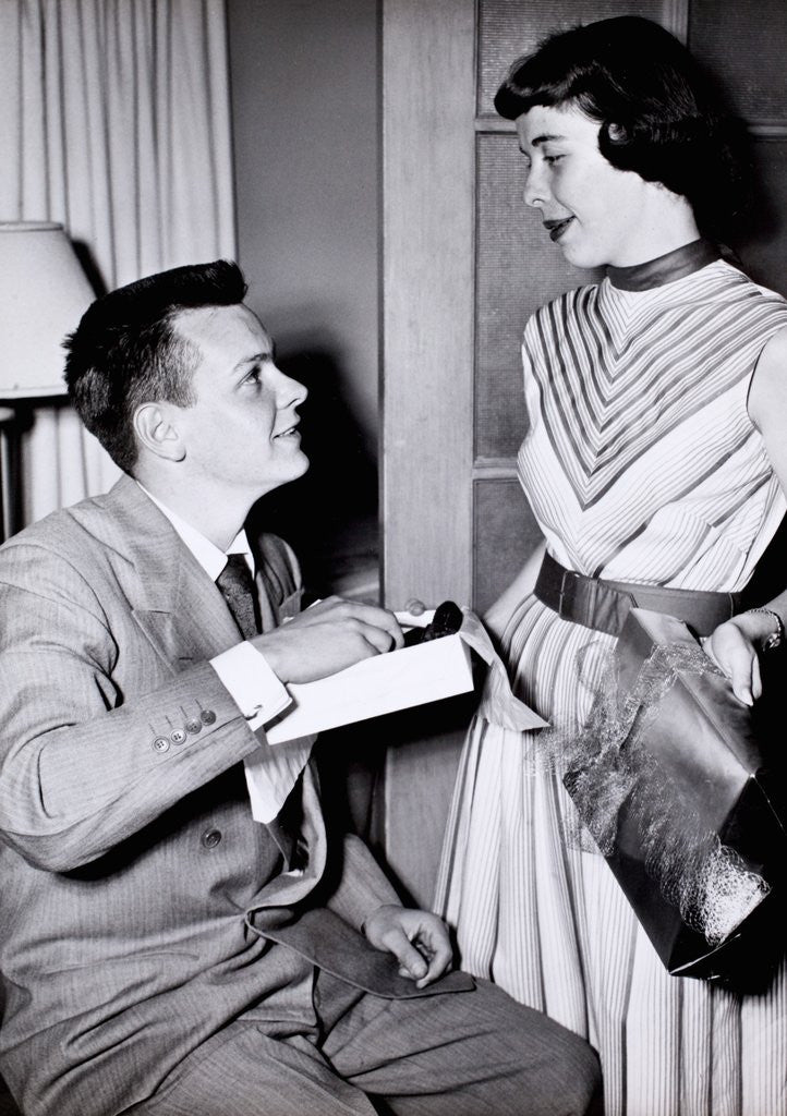 Detail of A couple exchange engagement gifts, ca. 1955 by Anonymous