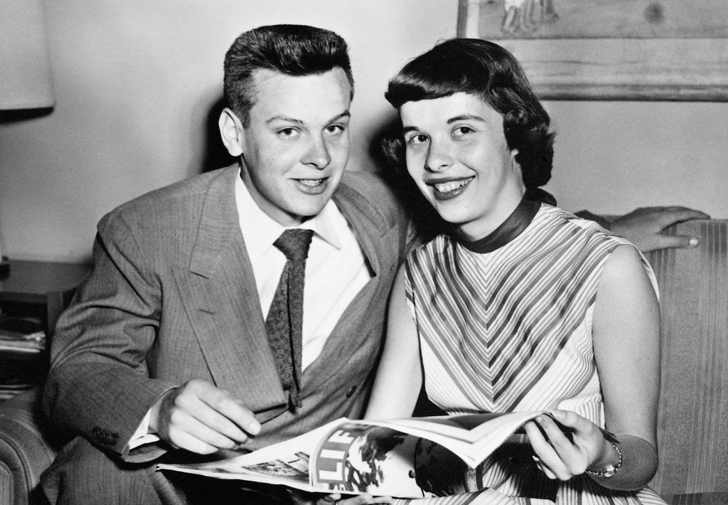 Detail of A couple pose on a couch while reading LIFE magazine, ca. 1955 by Anonymous