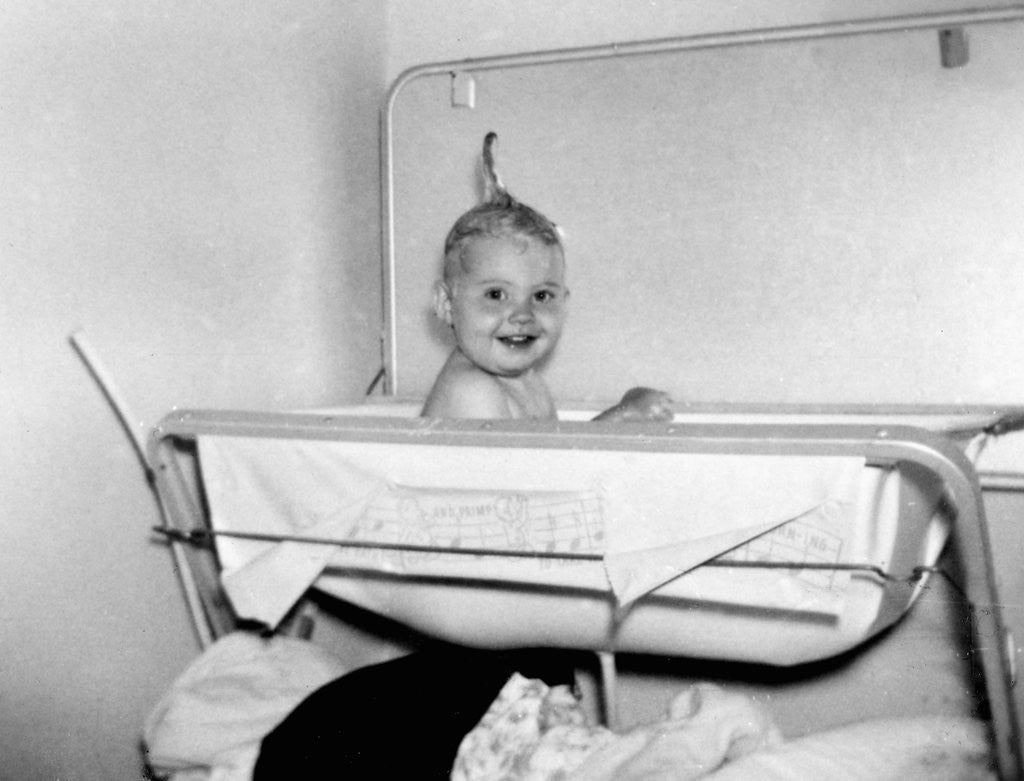 Detail of One year old baby girl enjoys her bath, ca. 1953 by Corbis