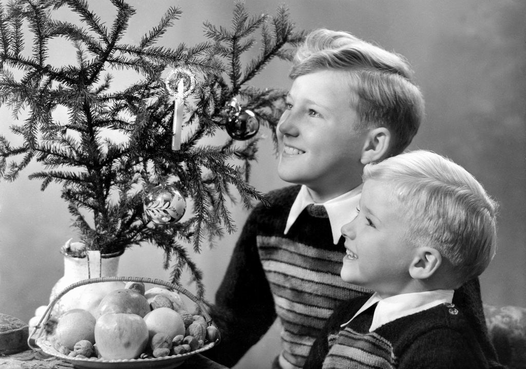 Detail of Two brothers look at a candle on a Christmas tree in Germany, ca. 1950 by Anonymous