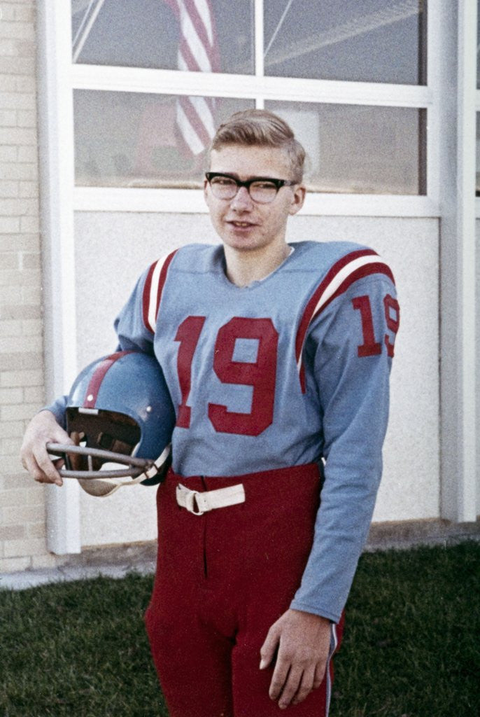 Detail of Fifteen year old high school football player portrait outside the school, ca. 1961 by Anonymous