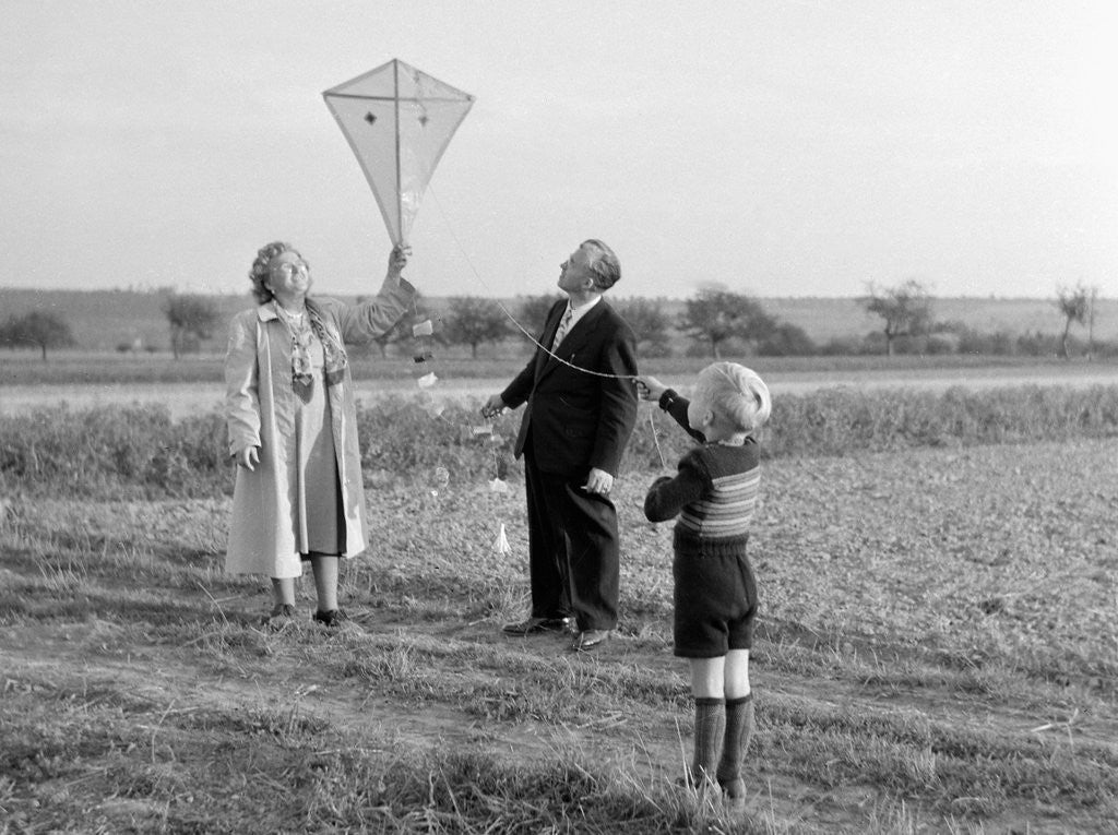 Detail of Five year old boy with mother and father fly a kite, ca. 1951 by Anonymous