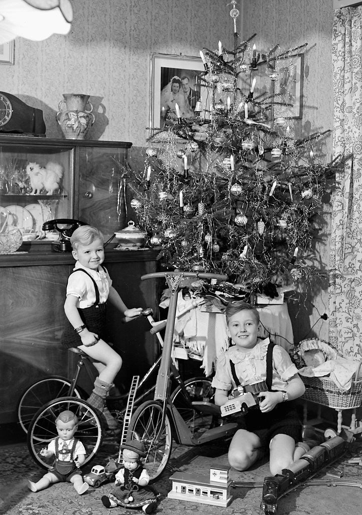 Detail of Two brothers are shown with their toys under the Christmas tree in Germany, ca. 1949 by Anonymous