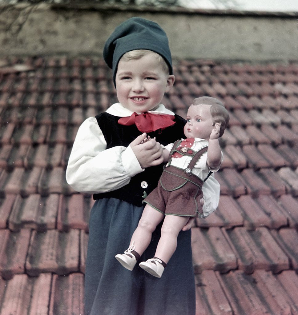 Detail of Four year old German boy stands with his lederhosen dressed doll, ca. 1949 by Anonymous