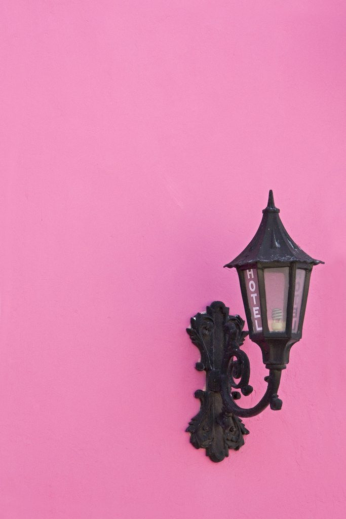 Detail of Street lamp on pink wall of Colonial style building by Anonymous