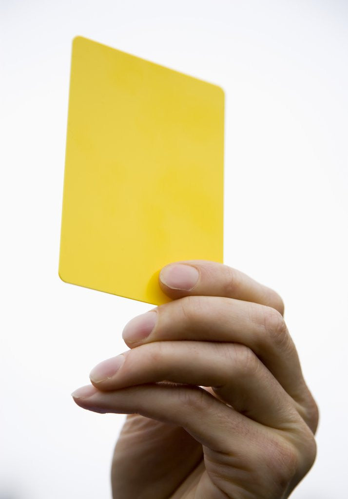 Detail of Hand holding yellow card by Anonymous
