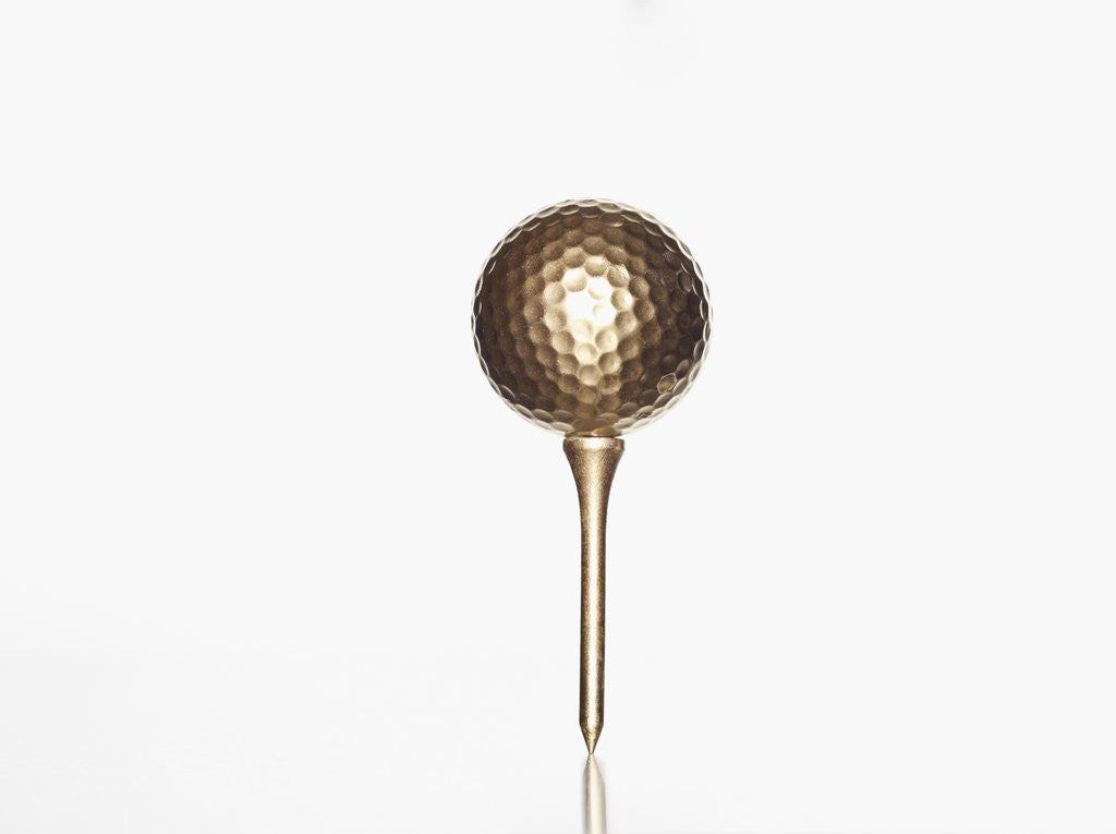 Detail of Gold golf ball and tee by Anonymous