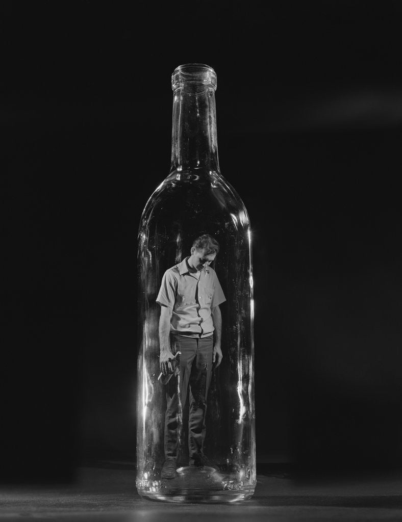 Detail of Sad man trapped inside bottle by Corbis