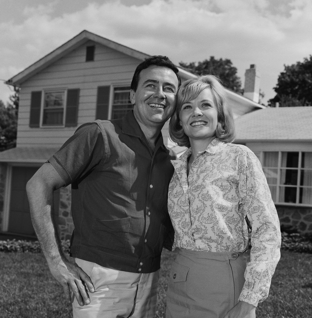 Detail of Happy couple portrait man woman smiling in front of home by Anonymous