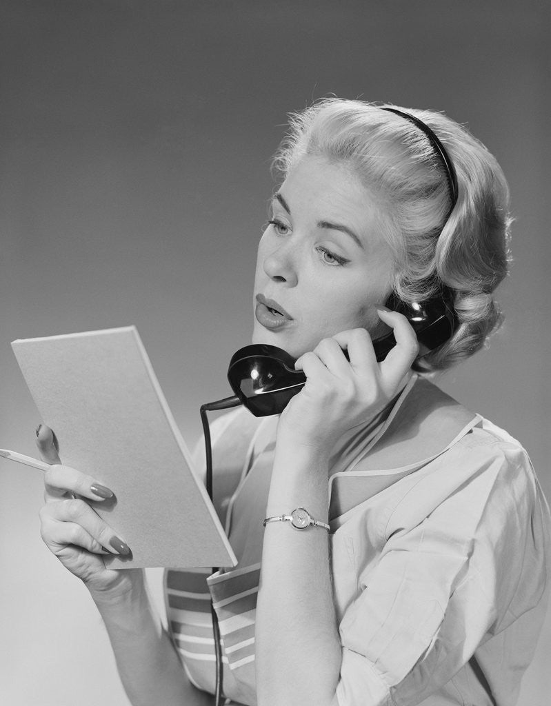 Detail of Blond woman talking on telephone reading list by Anonymous